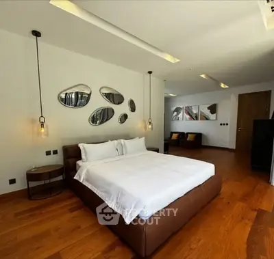 Luxurious modern bedroom with elegant decor and hardwood flooring