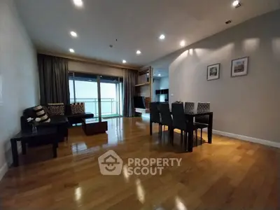 Spacious modern living room with hardwood floors and elegant dining area