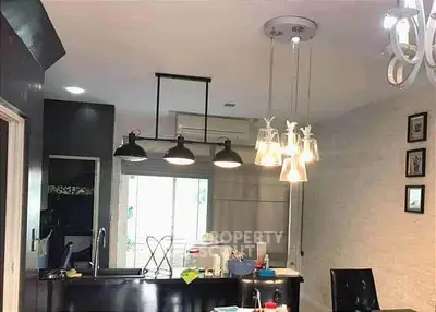 Modern kitchen with stylish lighting and open layout design, perfect for contemporary living.