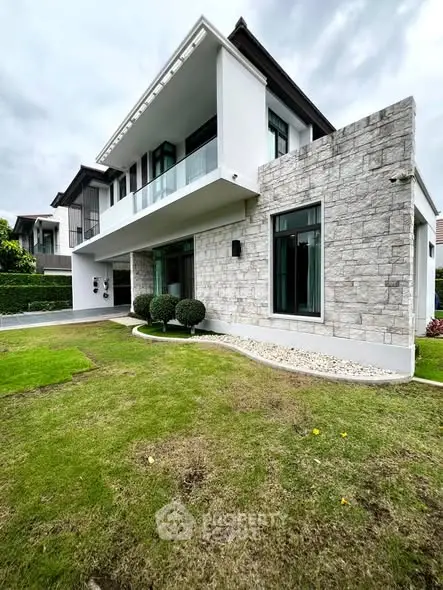 Modern two-story house with stone facade and lush green lawn