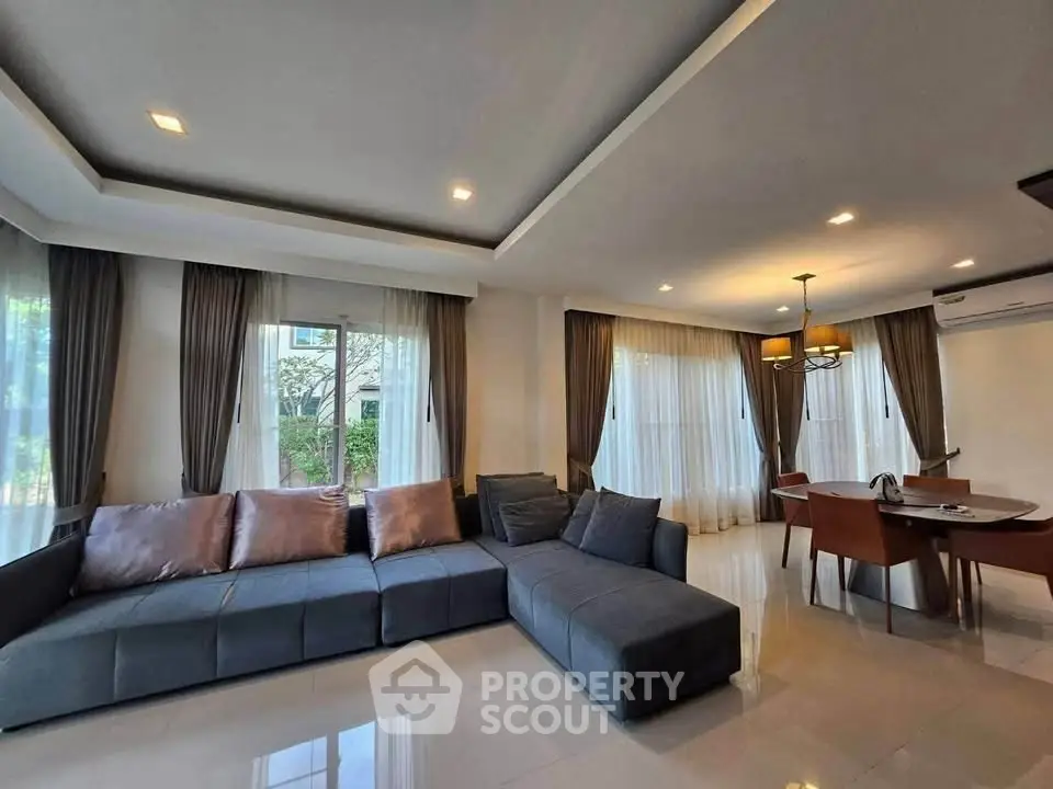 Spacious modern living room with elegant decor and large windows for natural light.