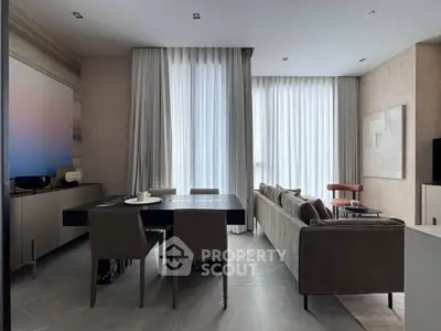 Modern living room with elegant dining area and floor-to-ceiling windows