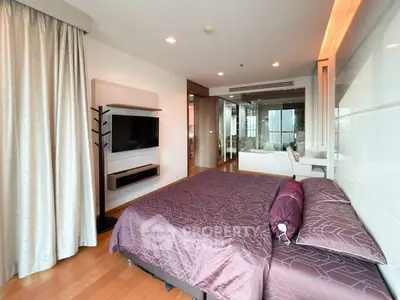 Luxurious modern bedroom with stylish decor and large windows offering natural light.