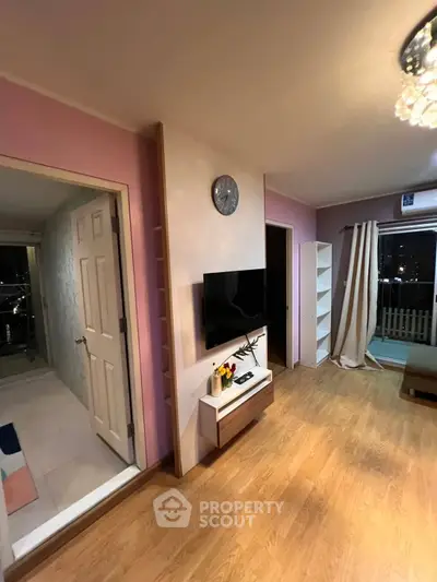 Charming living room with modern decor and balcony access, perfect for cozy evenings.