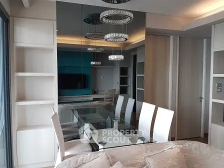Modern dining room with elegant glass table and stylish lighting in a contemporary apartment.