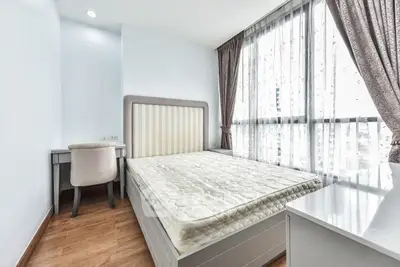 Bright and airy bedroom with large windows and elegant furnishings