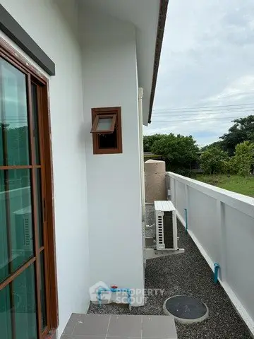 Charming balcony with serene garden view and modern exterior design