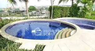 Luxurious outdoor pool with scenic view and lush greenery, perfect for relaxation and leisure.