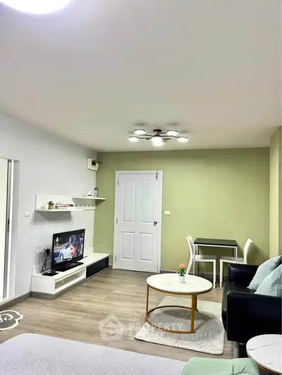 Modern living room with stylish furniture and wall-mounted TV, featuring a cozy ambiance.