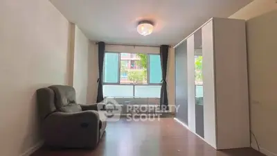 Spacious living room with modern decor and large windows for natural light.