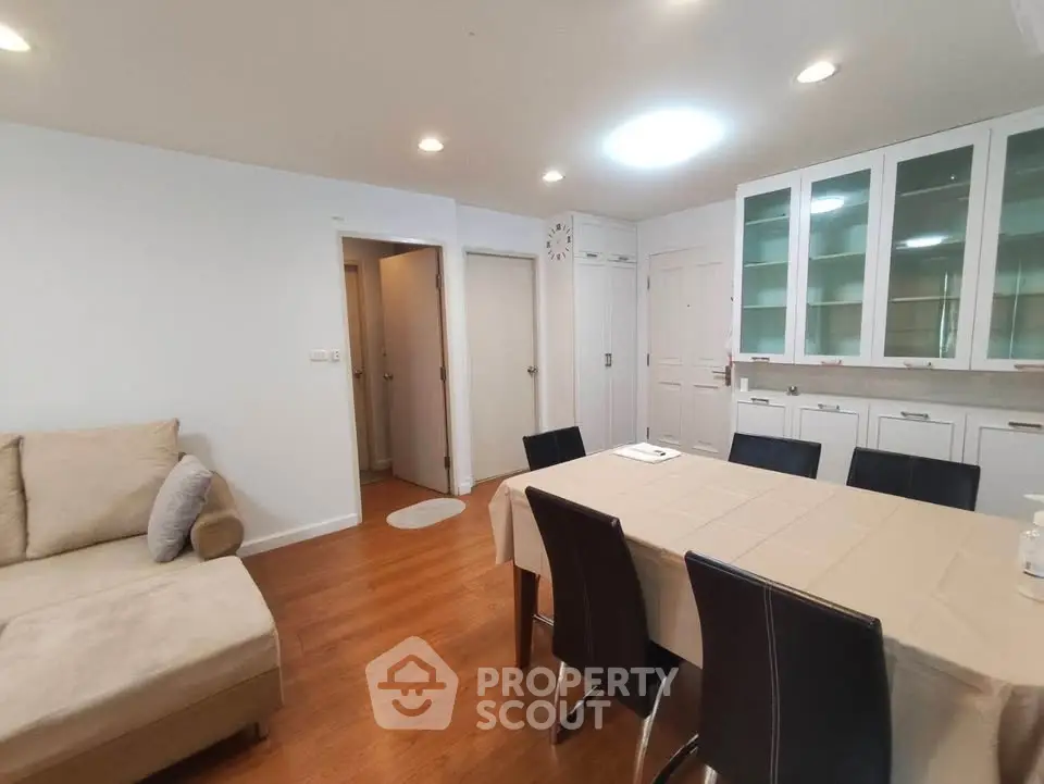Spacious living room with elegant dining area and modern decor.