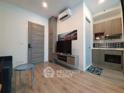 Modern living room with wooden flooring and stylish furniture in a cozy apartment.