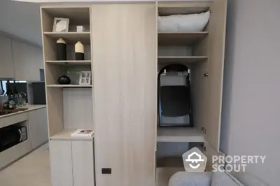 Modern apartment interior with stylish storage solutions and sleek kitchen design.