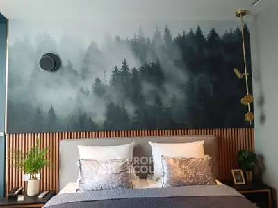 Luxurious bedroom with forest-themed accent wall and elegant lighting