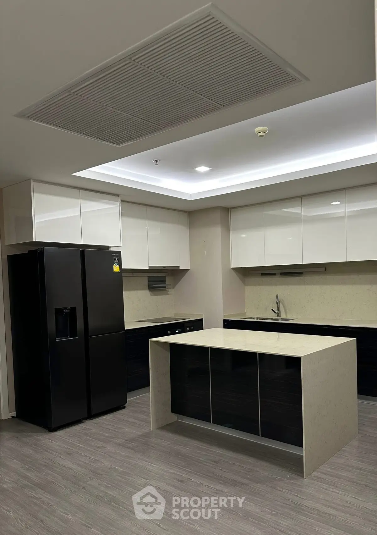 Modern kitchen with sleek black appliances and island counter