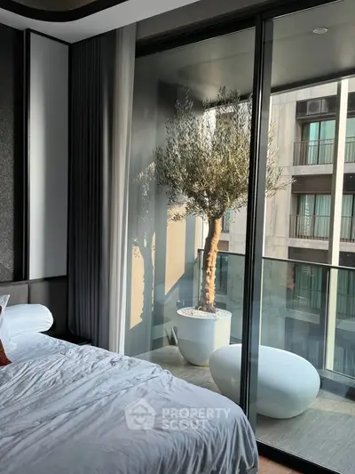 Luxurious bedroom with floor-to-ceiling windows and balcony view