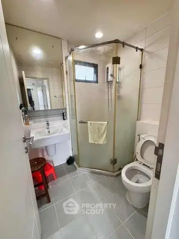 Modern bathroom with glass shower and sleek fixtures in a contemporary home.