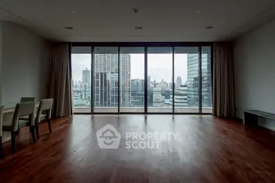 Spacious living room with stunning city view and hardwood floors