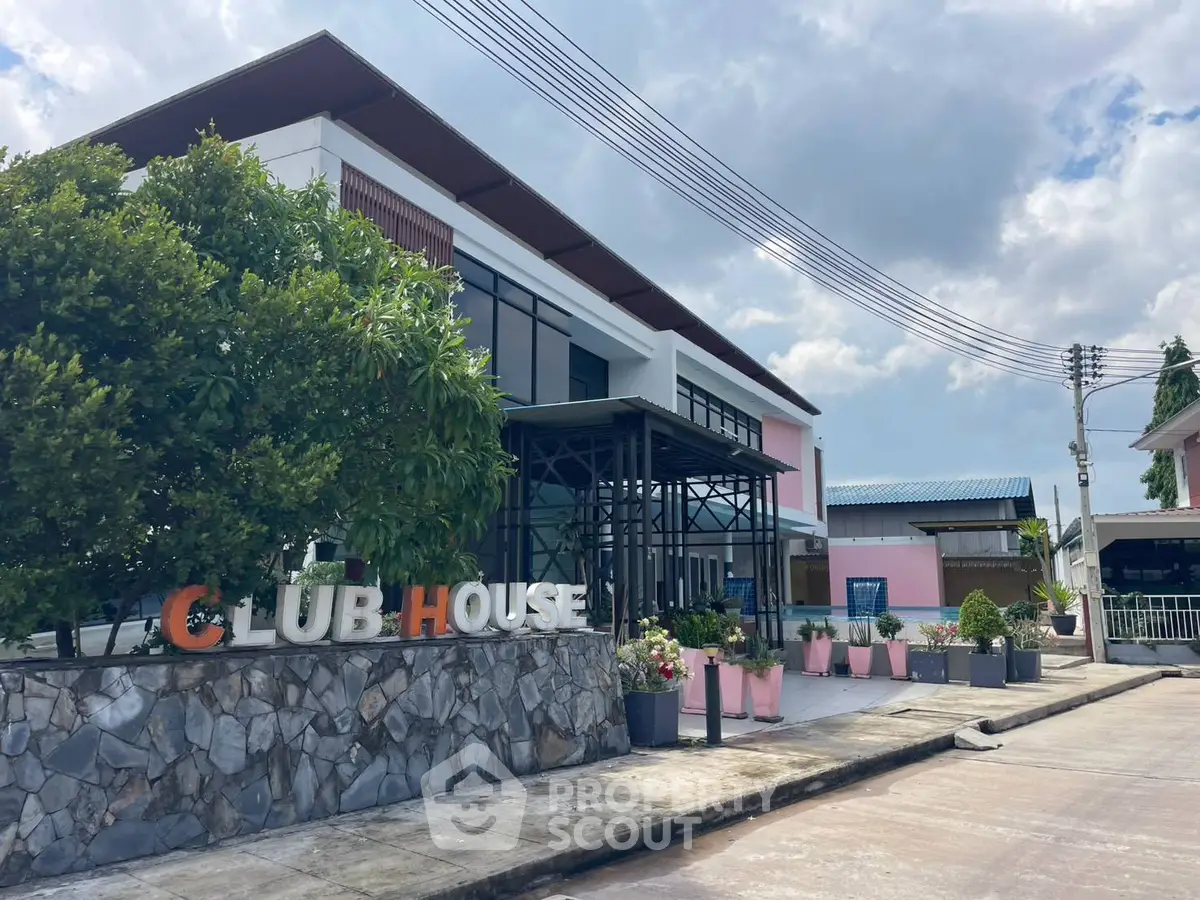 Modern clubhouse exterior with stylish design and lush greenery, perfect for community gatherings.