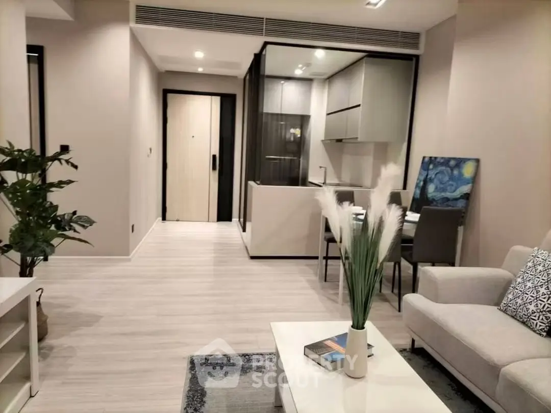 Modern living room with open kitchen and stylish decor in a contemporary apartment.