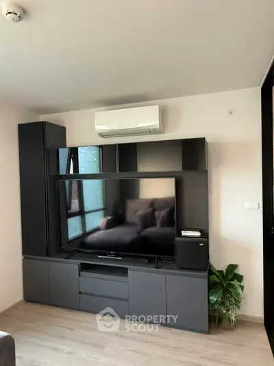 Modern living room with sleek entertainment unit and air conditioning