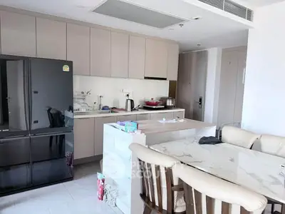 Modern kitchen with sleek cabinetry and marble dining table in a stylish apartment.