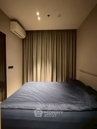 Cozy bedroom with modern air conditioning and elegant curtains