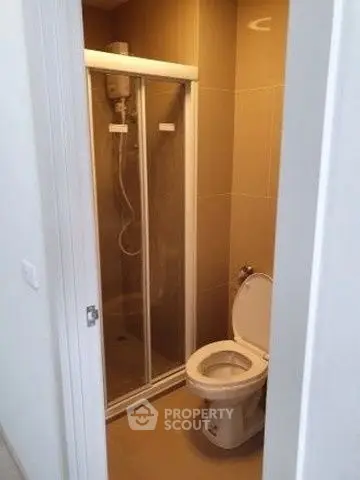 Compact bathroom with shower and toilet in modern apartment