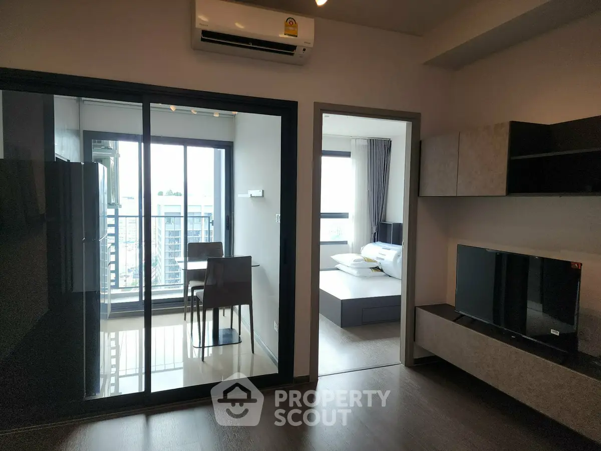 Modern apartment interior with living room, bedroom, and balcony view
