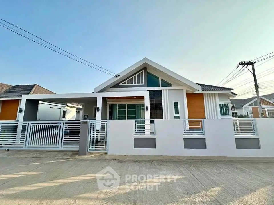 Modern single-story house with sleek design and spacious driveway in a serene neighborhood.