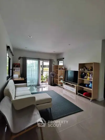 Spacious living room with modern decor and large windows for natural light