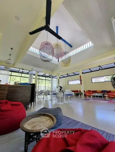 Spacious modern living room with high ceilings and colorful decor