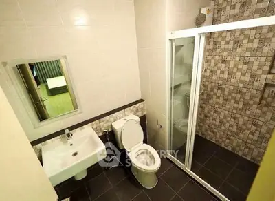 Modern bathroom with stylish tile design and glass shower enclosure