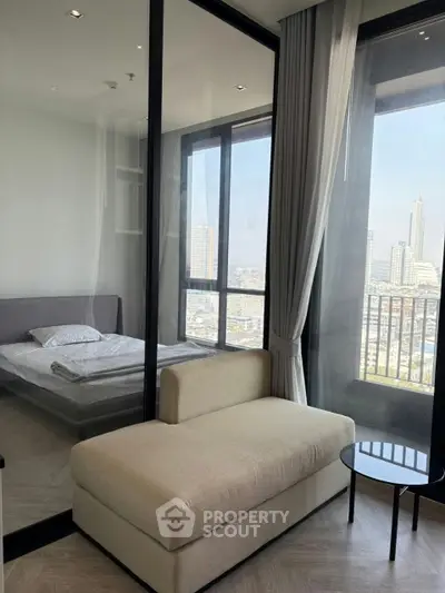 Modern bedroom with glass partition and city view in high-rise apartment