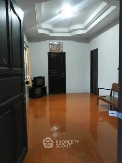 Spacious interior with glossy tile flooring and modern ceiling design, ideal for cozy living.