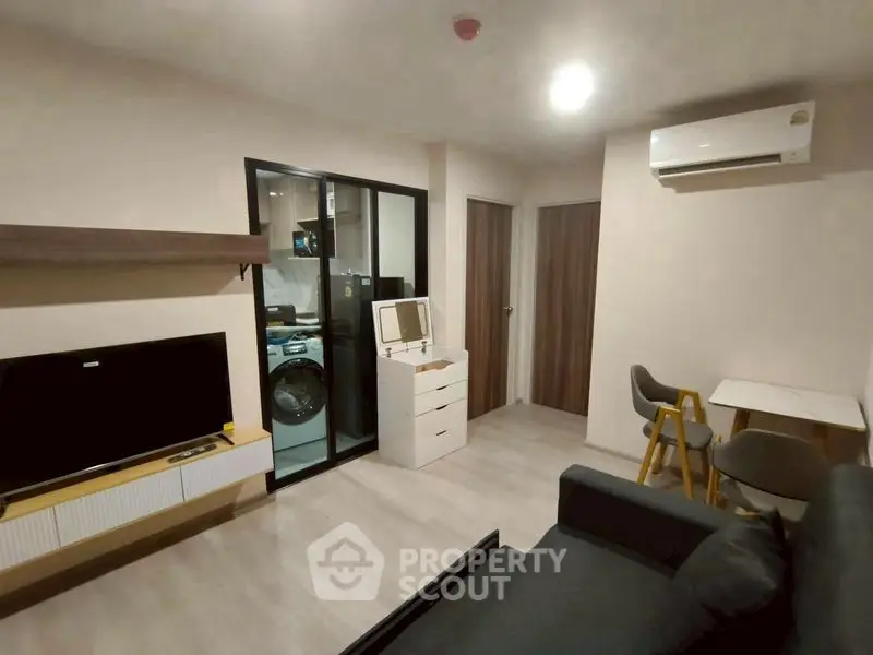 Modern living room with sleek furniture and open kitchen view