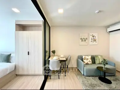 Modern living room with cozy sofa, dining area, and stylish decor in a bright apartment.