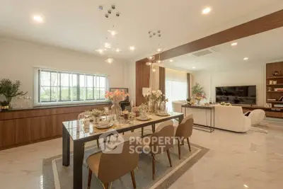 Luxurious open-plan living and dining area with elegant decor and modern furnishings.