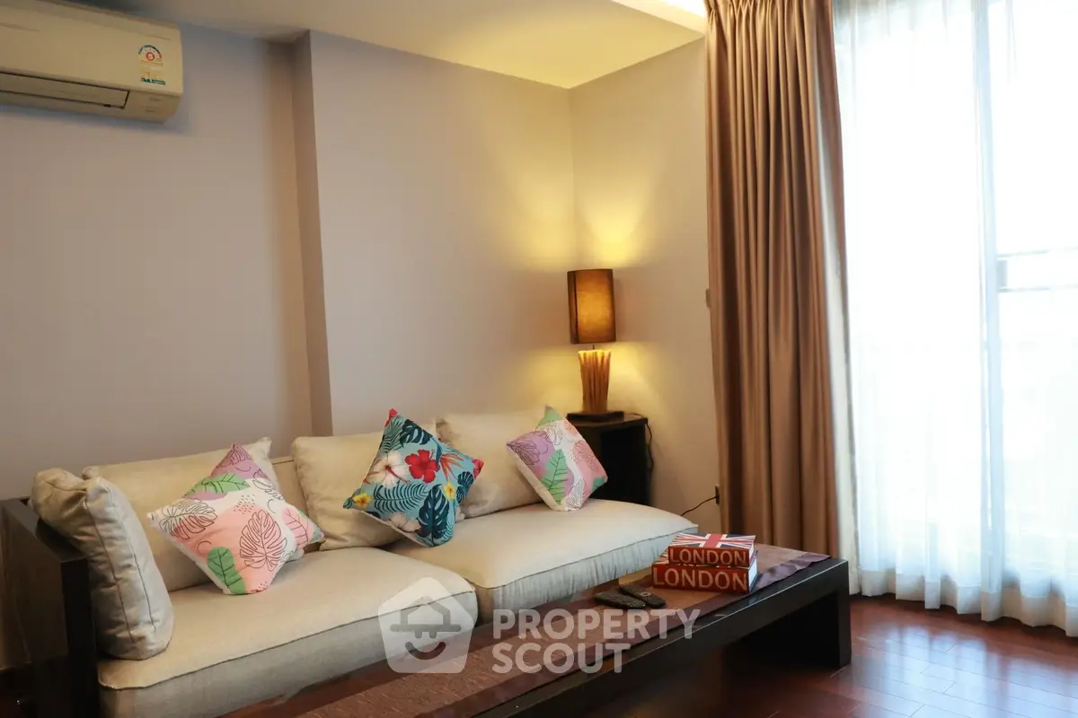 Cozy living room with elegant sofa and natural light, perfect for relaxation.