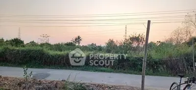 Scenic view of lush greenery and open road, perfect for future real estate development.