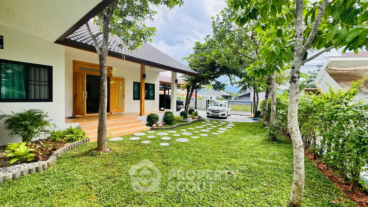 Charming single-story home with lush garden and carport in serene neighborhood.