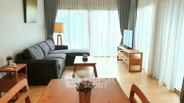 Spacious living room with modern furniture and large windows for natural light.