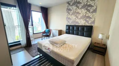 Modern bedroom with stylish decor and city view from large window