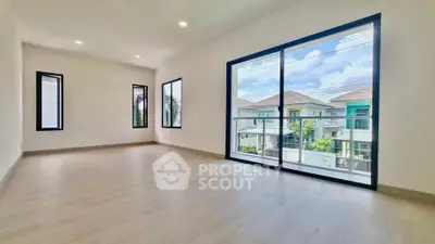 Spacious modern living room with large windows and natural light