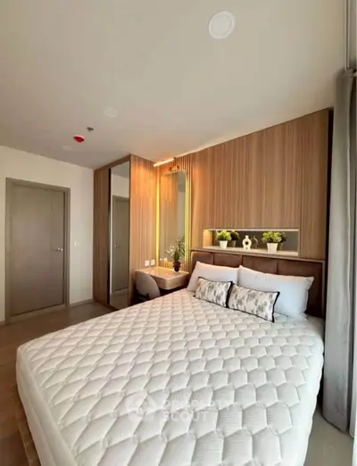 Modern bedroom with stylish decor and cozy ambiance, featuring a comfortable bed and elegant wooden accents.