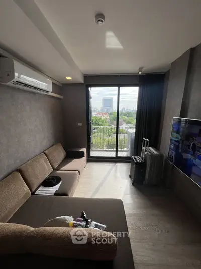 Modern living room with balcony view and stylish furniture in urban apartment