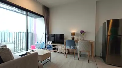 Modern living room with balcony view and stylish furniture in a high-rise apartment.