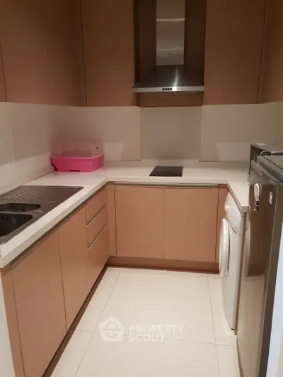 Modern kitchen with sleek cabinetry and built-in appliances in a compact layout.