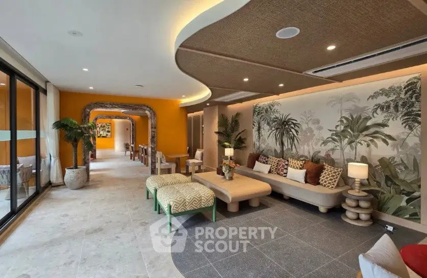 Luxurious living room with modern decor and tropical accents, featuring elegant seating and ambient lighting.