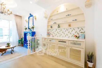 Charming living room with elegant decor and built-in shelving, featuring a cozy seating area and stylish accents.